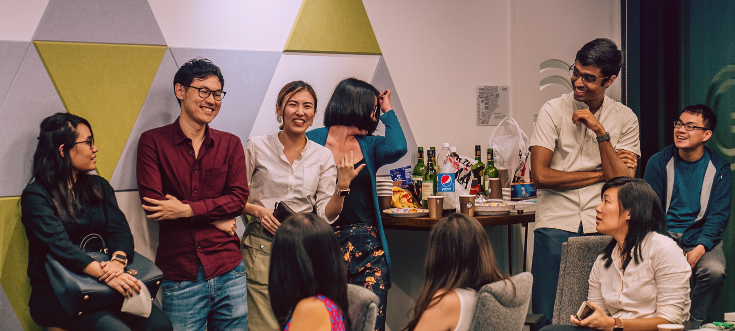 Group photo of people laughing while networking at a better.sg event